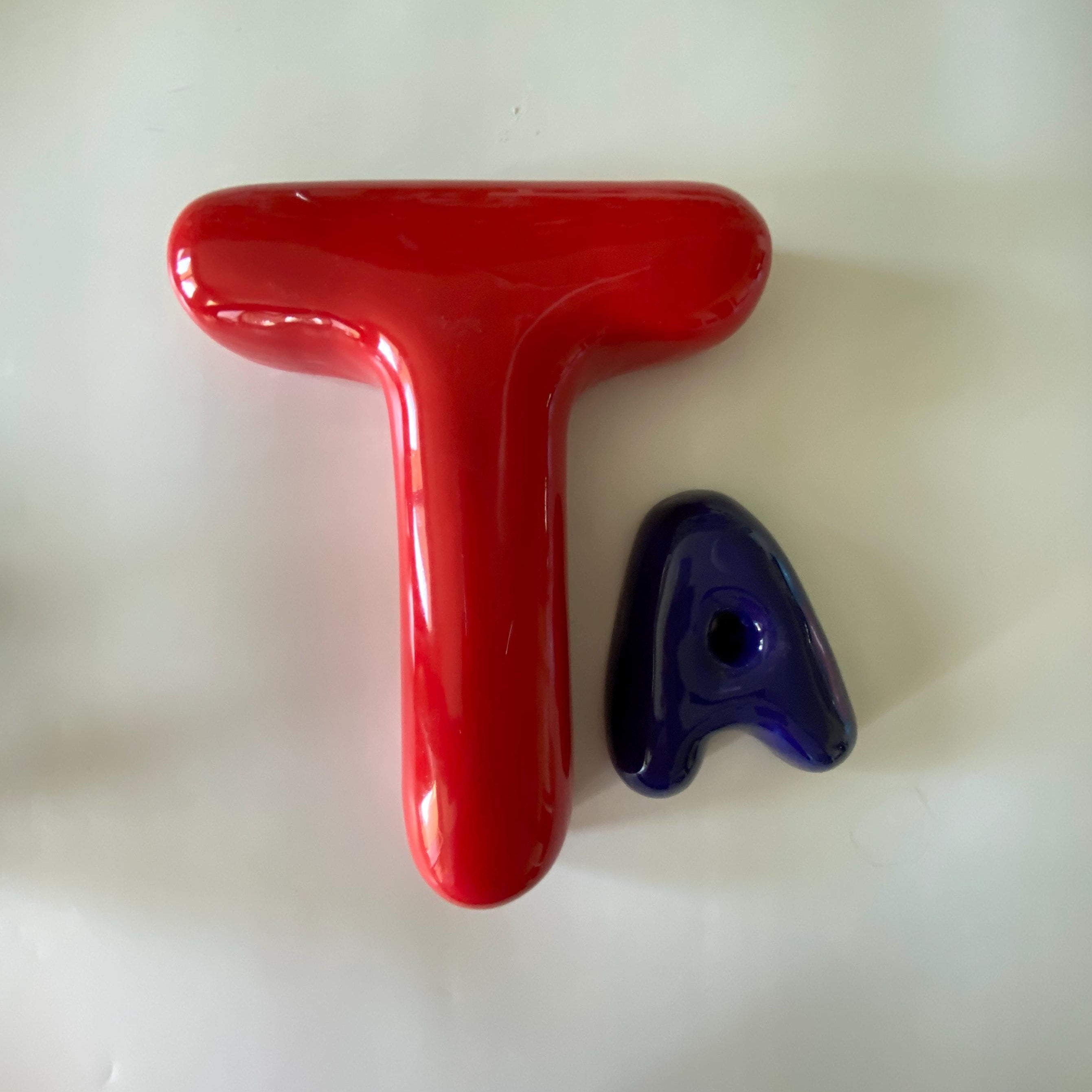 Red and blue letter 'T' shaped objects on a white background